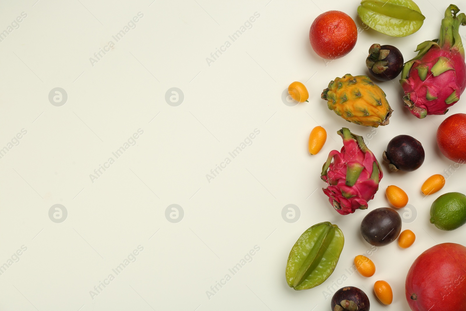 Photo of Assortment of fresh exotic fruits on white background, flat lay. Space for text