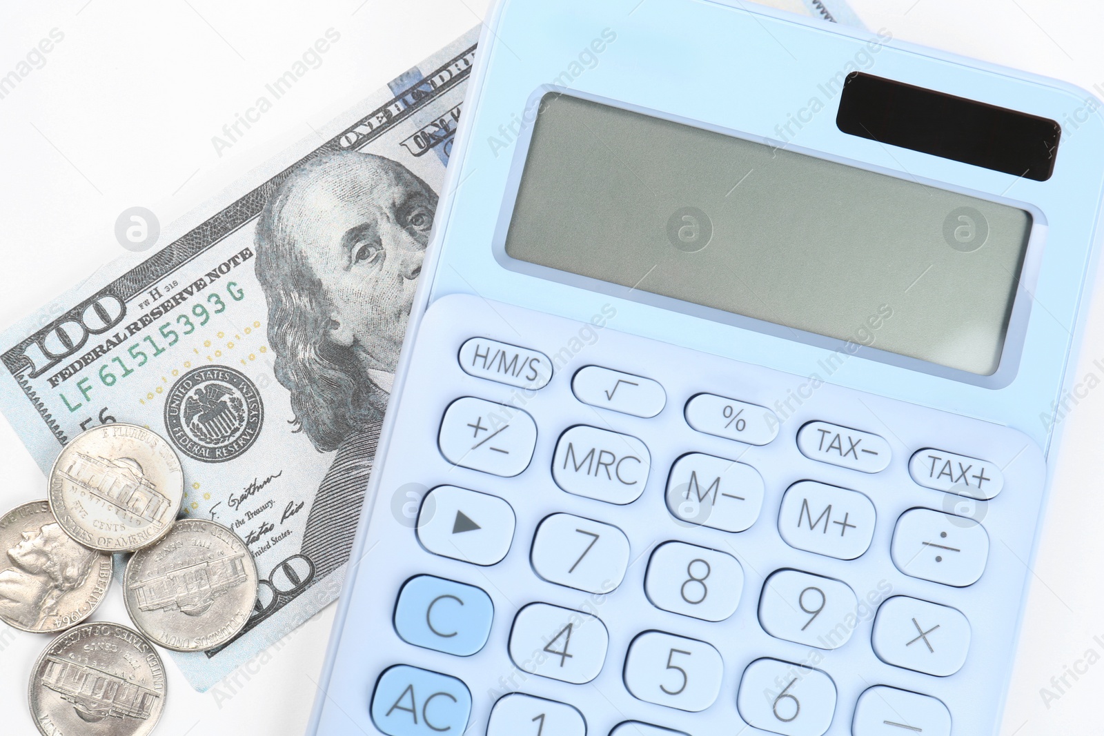 Photo of Calculator, dollar banknote and coins on white background, top view. Retirement concept