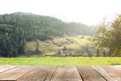 Empty wooden surface and beautiful view of conifer mountain forest