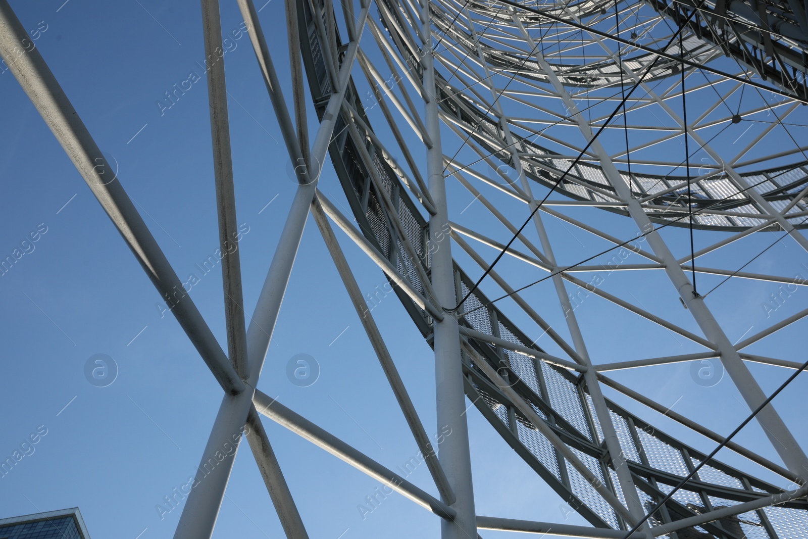 Photo of Structure of modern tower against blue sky, bottom view