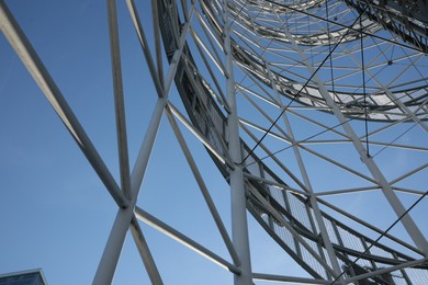 Photo of Structure of modern tower against blue sky, bottom view