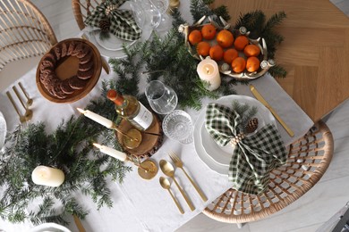 Christmas table setting with festive decor and dishware, top view