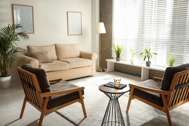 Photo of Living room interior with comfortable sofa and armchairs