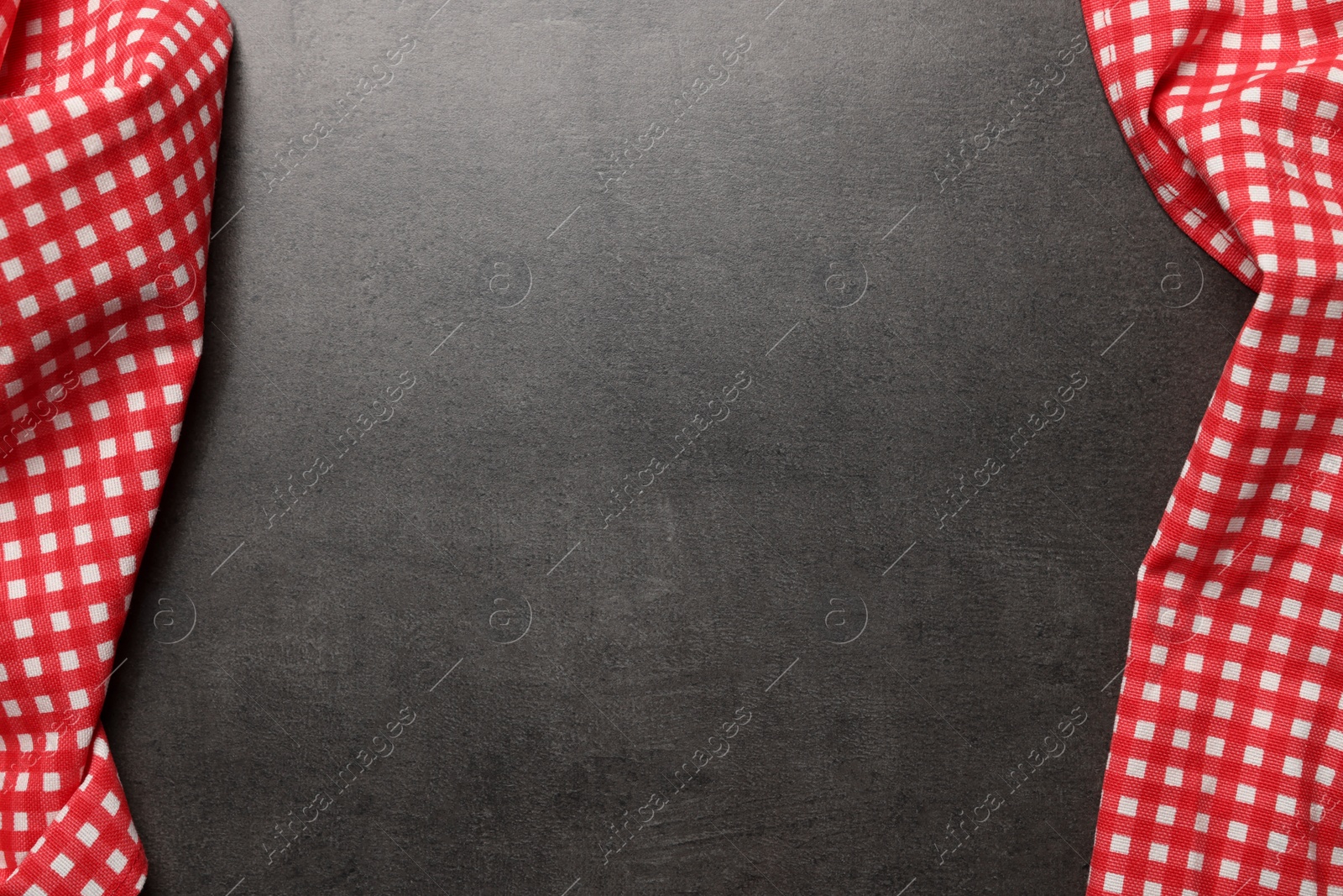 Photo of Checkered tablecloths on grey background, flat lay. Space for text