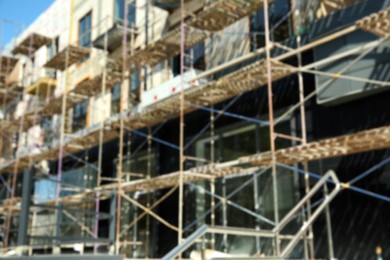 Photo of Blurred view of unfinished building with scaffolding