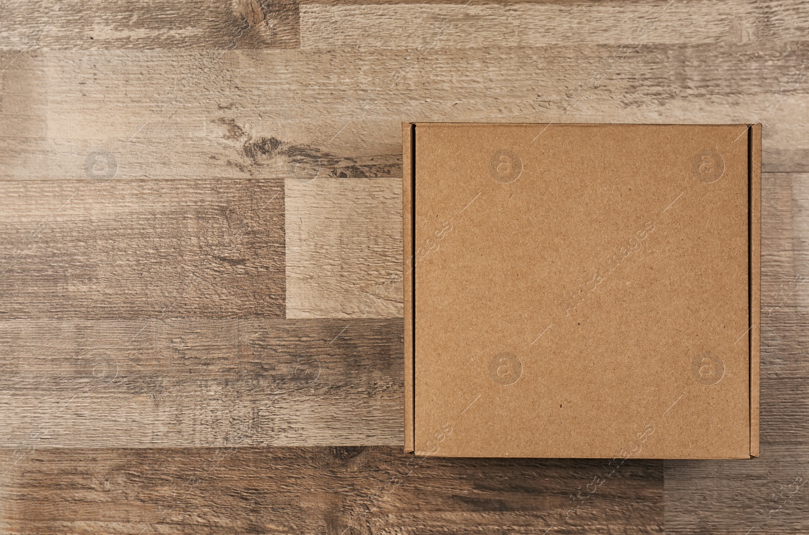 Photo of Cardboard box on wooden floor