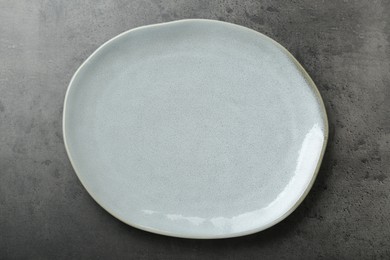 Photo of Empty ceramic plate on grey table, top view