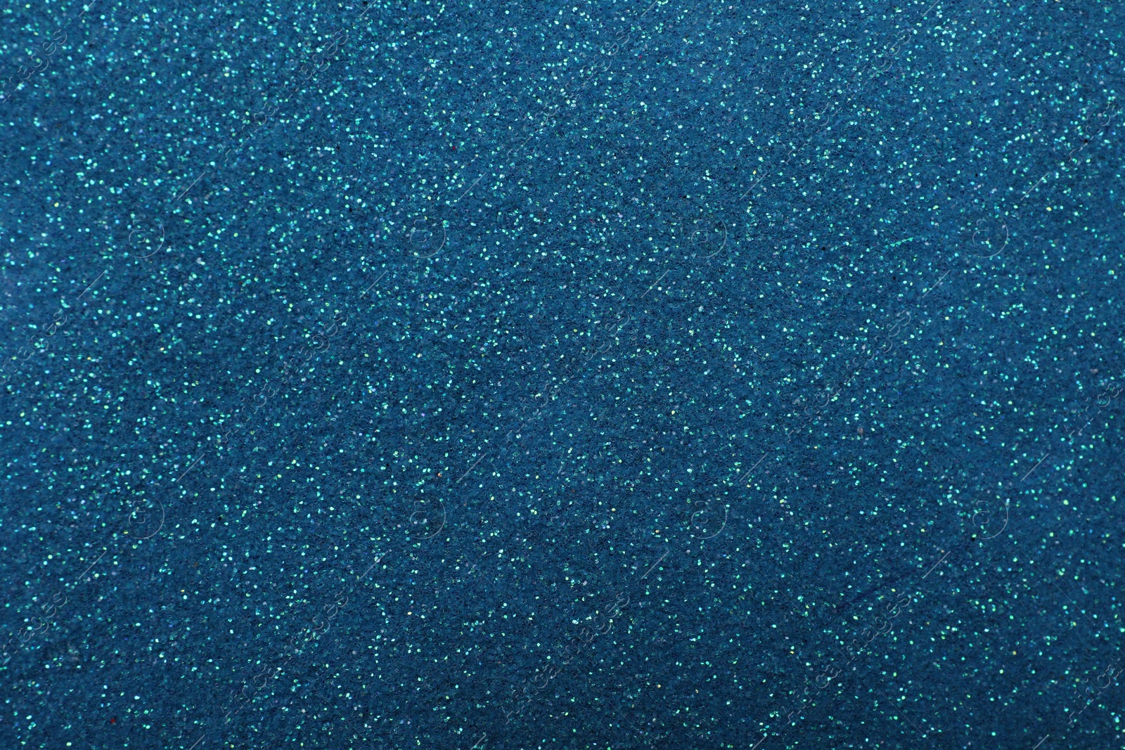 Photo of Shiny light blue glitter as background, closeup