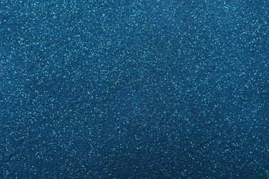 Photo of Shiny light blue glitter as background, closeup