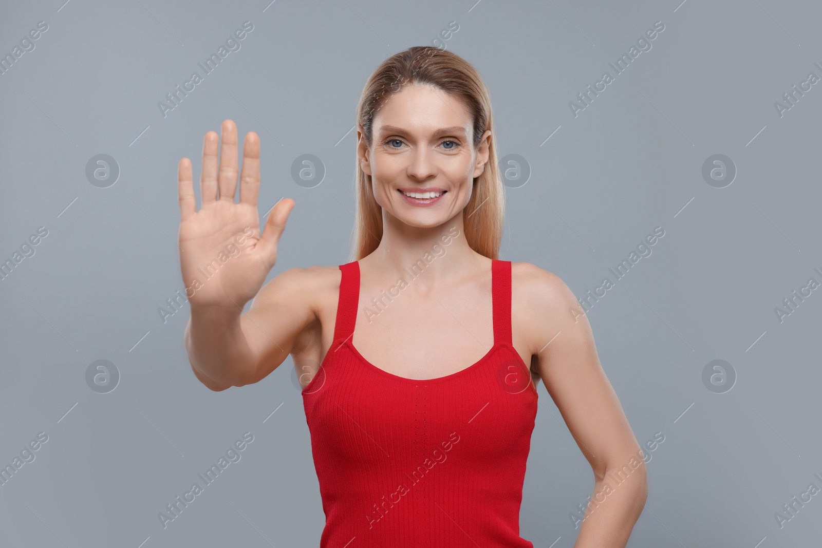 Photo of Woman giving high five on grey background