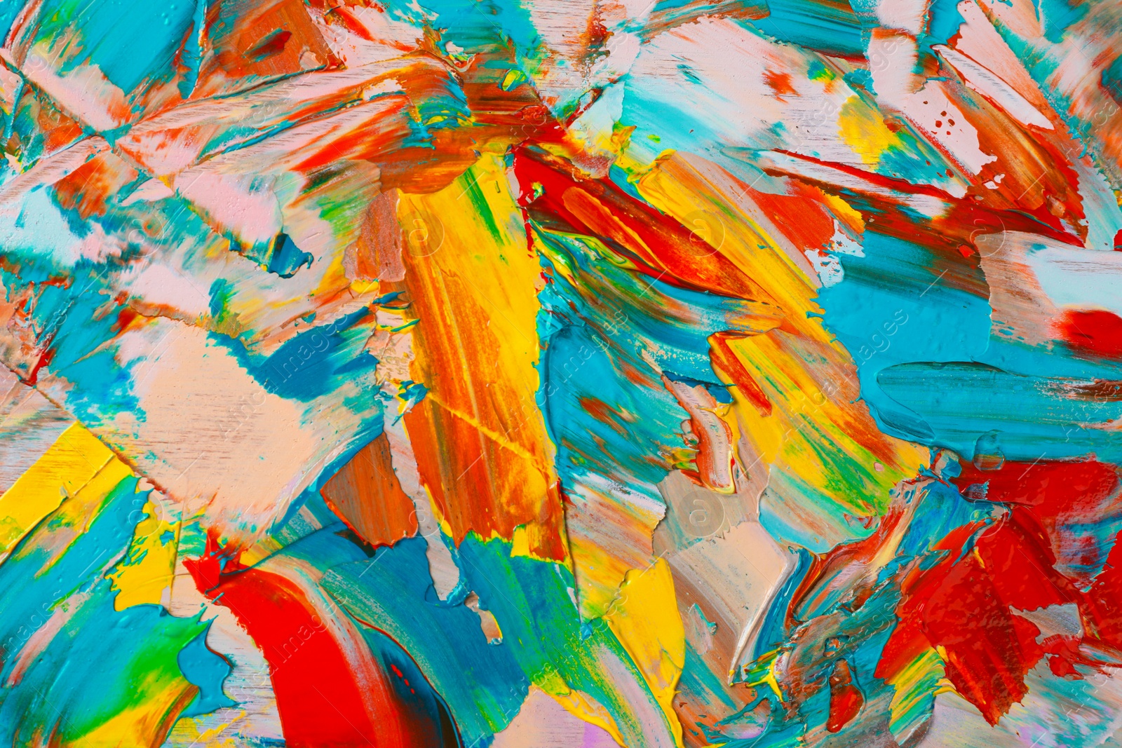 Photo of Closeup view of artist's palette with mixed bright paints as background