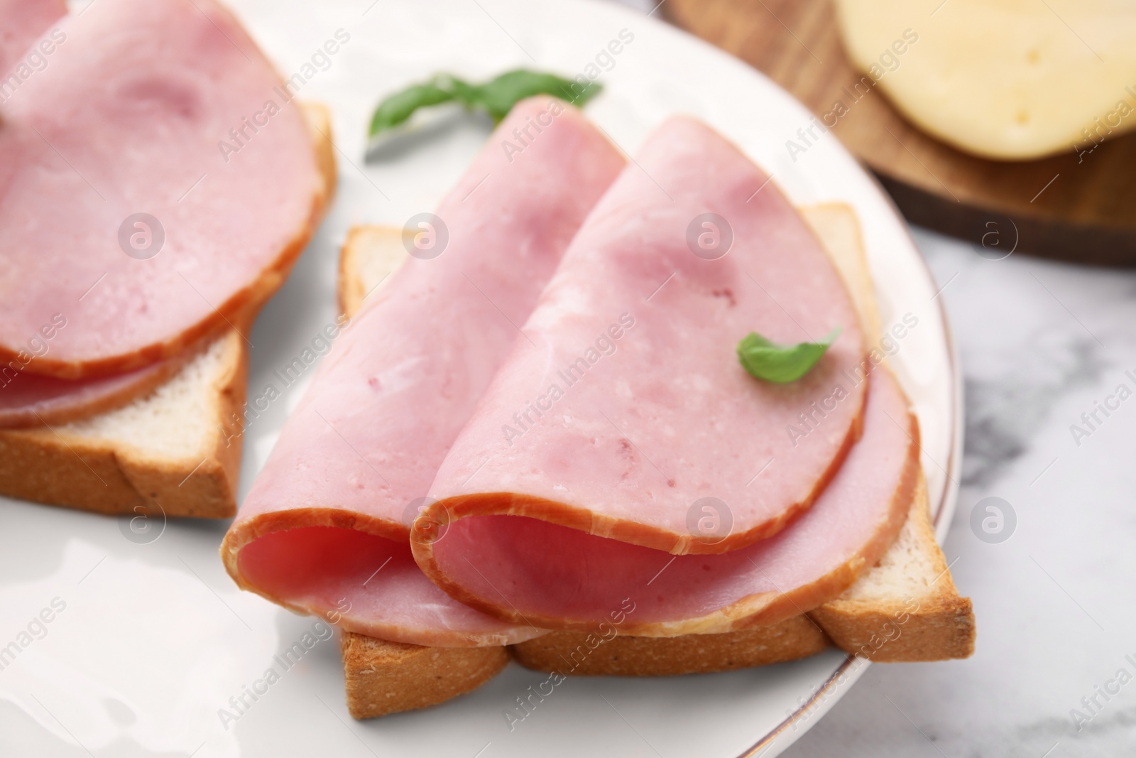 Photo of Delicious sandwiches with ham on table, closeup