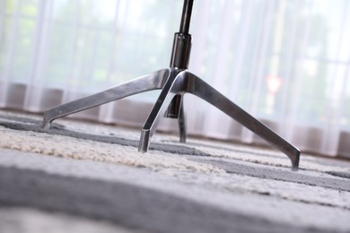 Modern office chair on carpet, closeup view