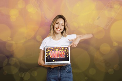 Image of Betting. Happy woman pointing at laptop with word Win! against blurred background