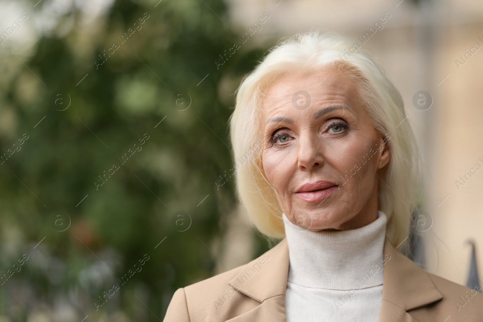 Photo of Portrait of elegant mature woman outdoors. Space for text