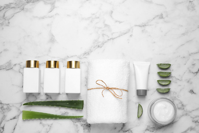 Photo of Flat lay composition with aloe vera and cosmetic products on white marble background. Space for text