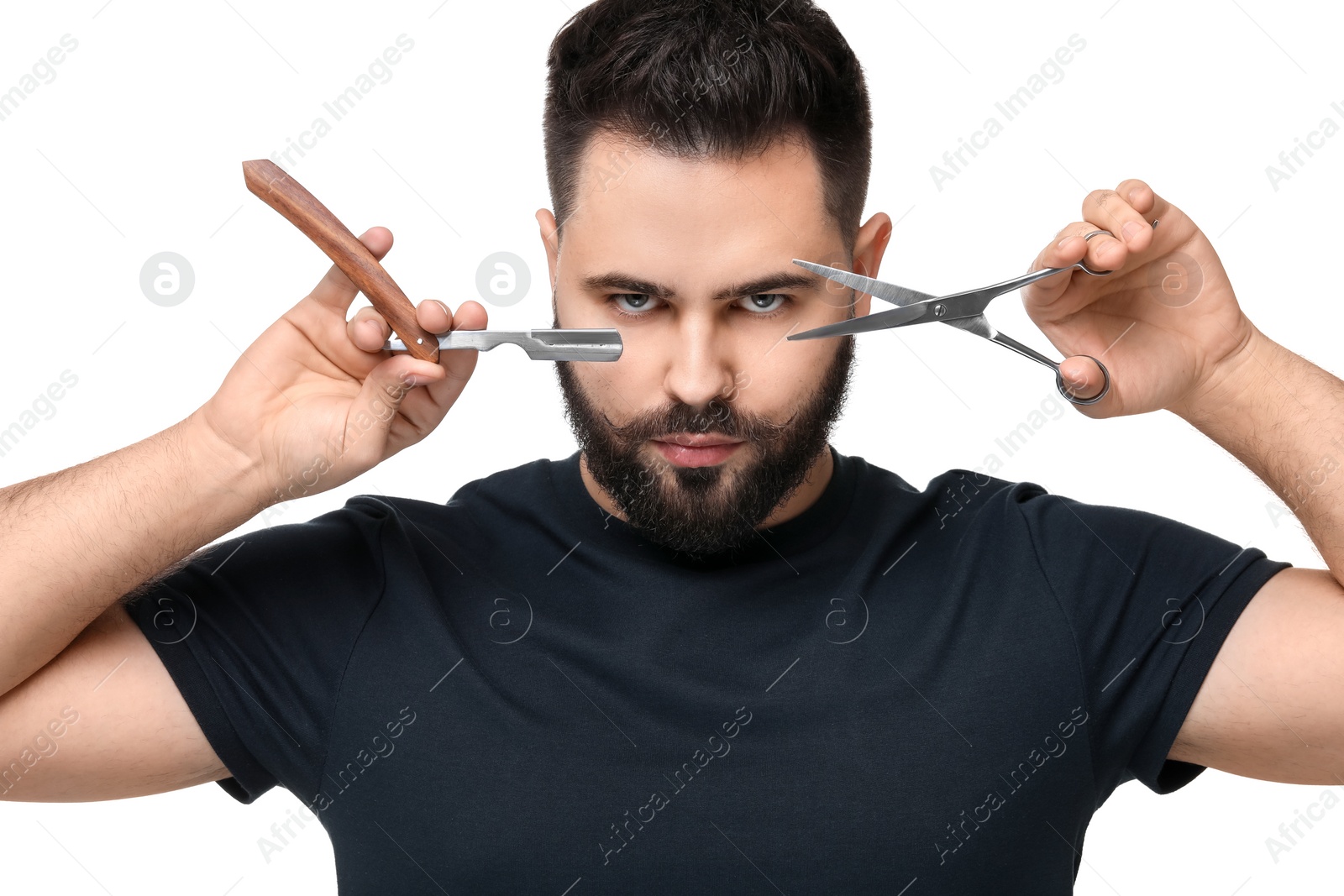 Photo of Handsome young man with mustache holding blade and scissors on white background