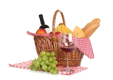 Photo of Picnic basket with food and glass of wine on white background