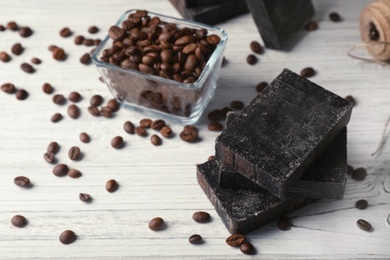 Photo of Handmade soap bars and coffee beans on table