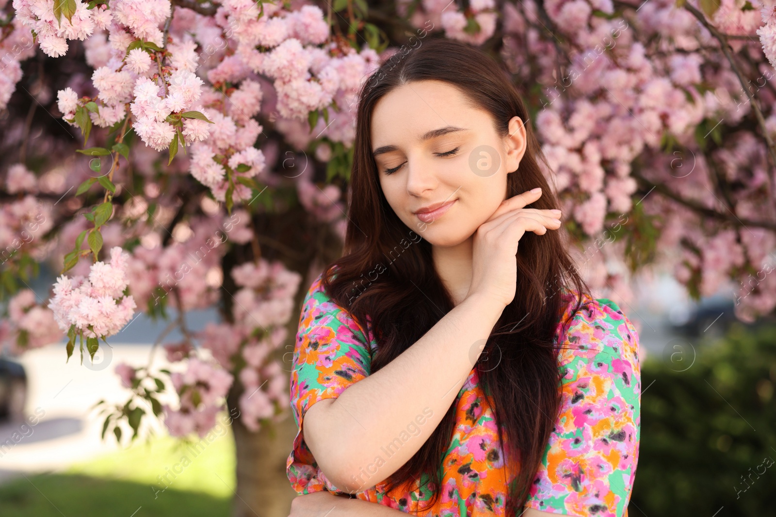 Photo of Beautiful woman near blossoming tree on spring day