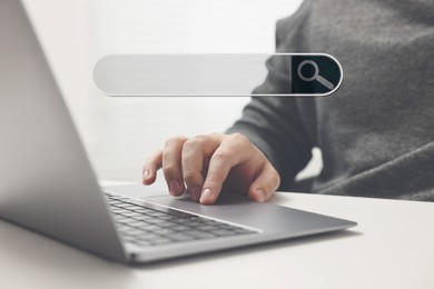 Image of Search bar of website over laptop. Man using computer at white table, closeup