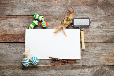 Photo of Flat lay composition with cat accessories on wooden background