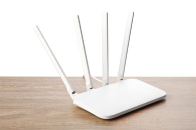 Photo of New modern Wi-Fi router on wooden table against white background