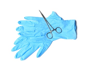 Photo of Protective gloves and medical clamp on white background, top view