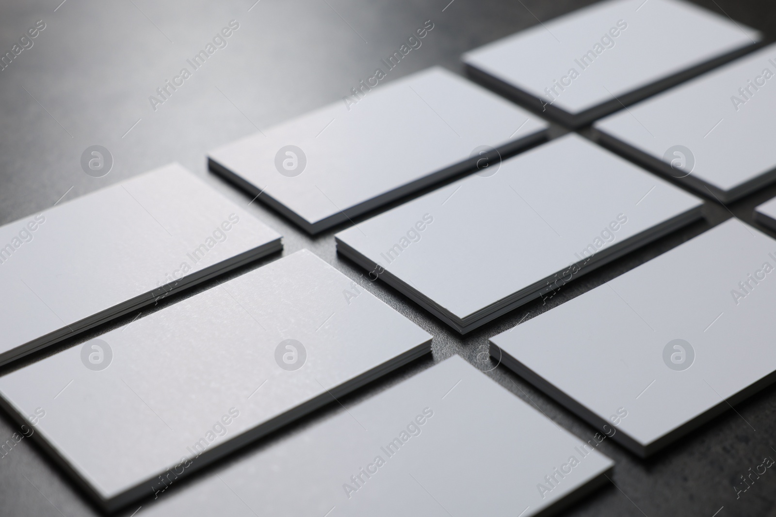 Photo of Blank business cards on grey textured table, closeup. Mockup for design