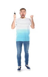 Photo of Happy young man with car key on white background. Getting driving license