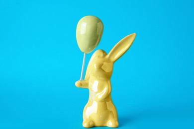 Bunny ceramic figure as Easter decor on blue background