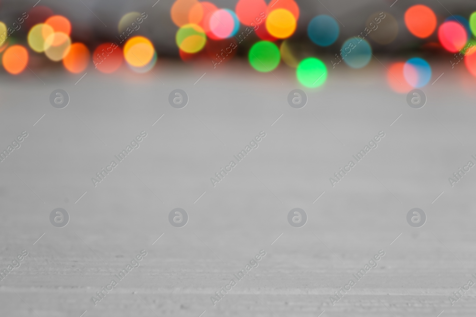Photo of Colorful lights on light table, blurred view. Space for text