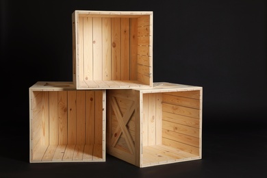 Photo of Group of wooden crates on black background