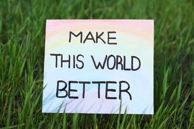 Photo of Card with text Make This World Better in green grass