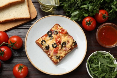 Tasty pizza toast and ingredients on wooden table, flat lay