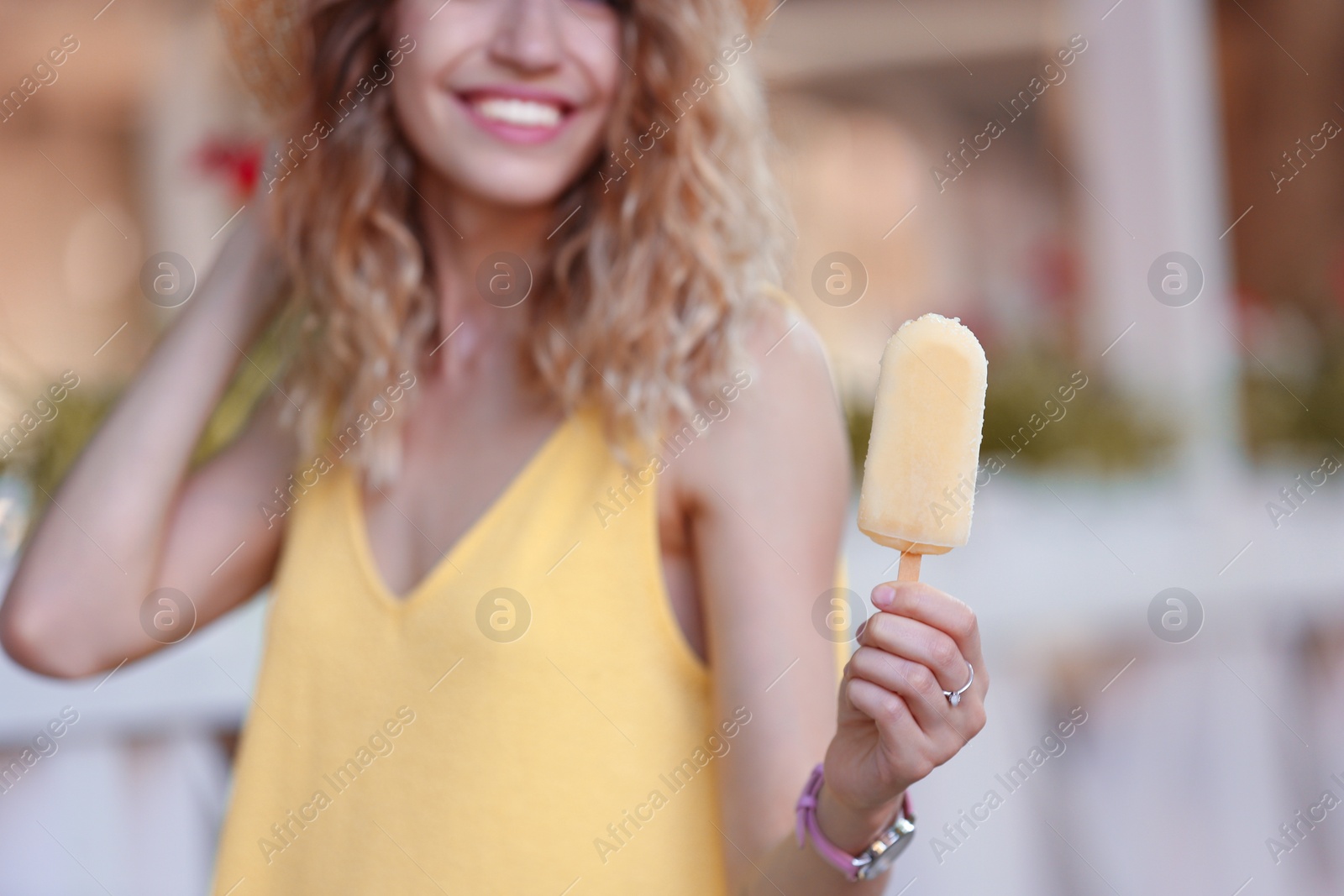 Photo of Happy young woman with delicious ice cream outdoors, closeup