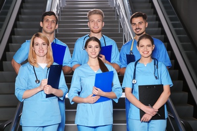 Young smiling medical students in university hall