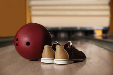 Photo of Shoes and ball on alley in bowling club