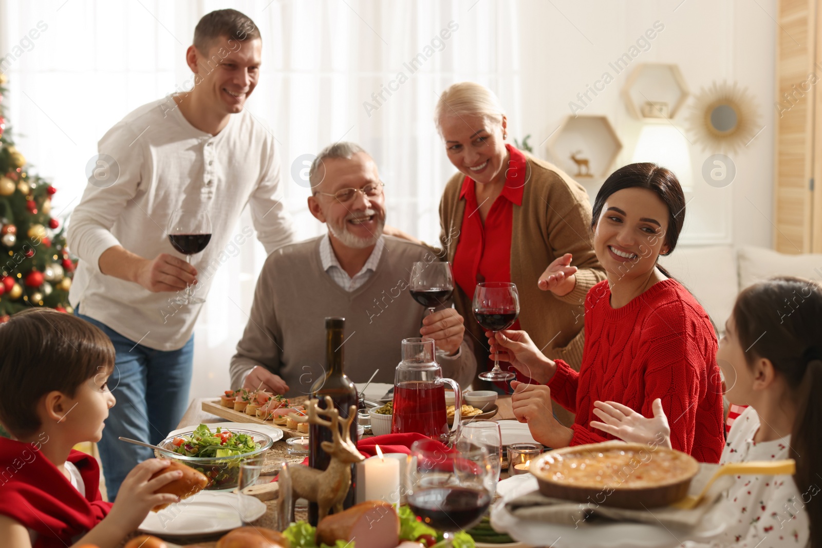 Photo of Happy family enjoying festive dinner at home. Christmas celebration