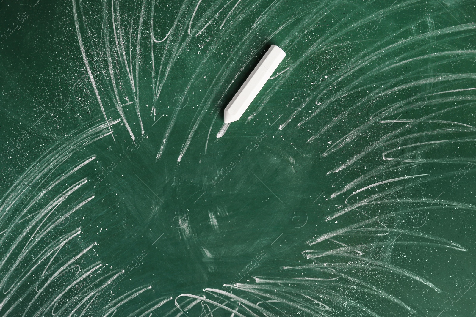 Photo of Chalk on green board, closeup. School equipment