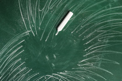 Chalk on green board, closeup. School equipment
