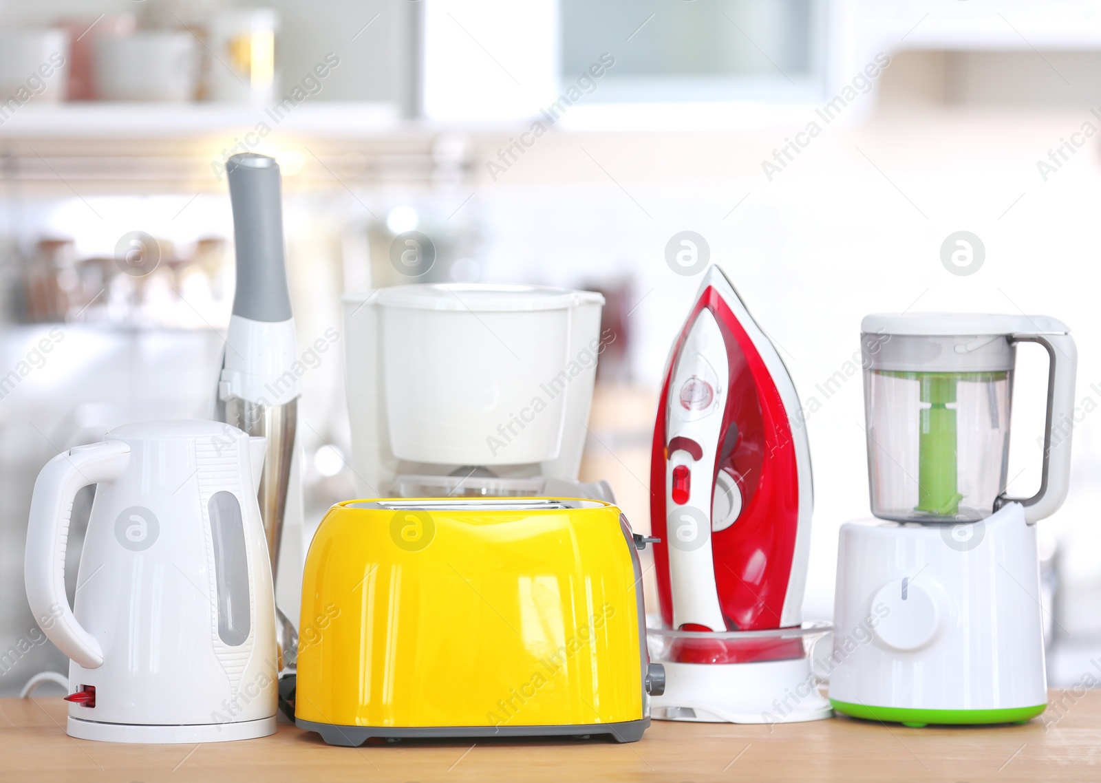 Photo of Household and kitchen appliances on table indoors. Interior element