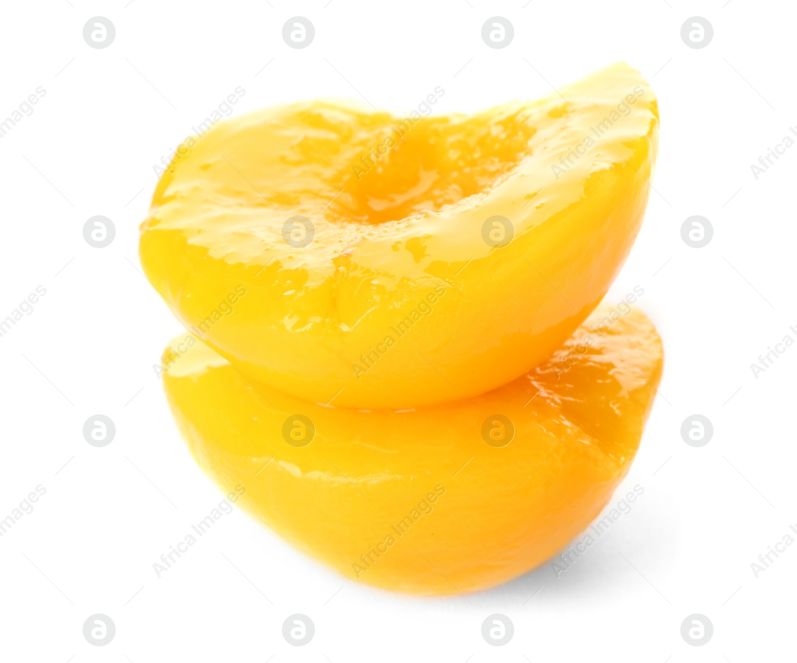 Photo of Halves of canned peach on white background