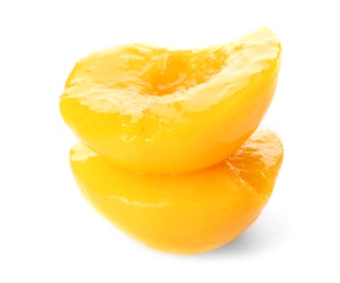 Halves of canned peach on white background