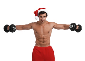 Sexy shirtless Santa Claus with dumbbells on white background