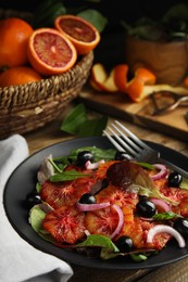Photo of Plate of delicious sicilian orange salad on wooden table, closeup