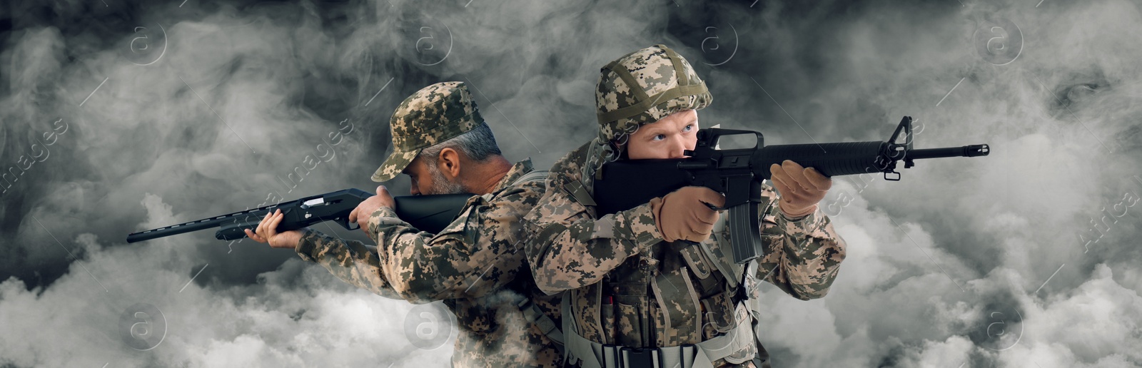 Image of Armed soldiers in smoke on battlefield. Banner design