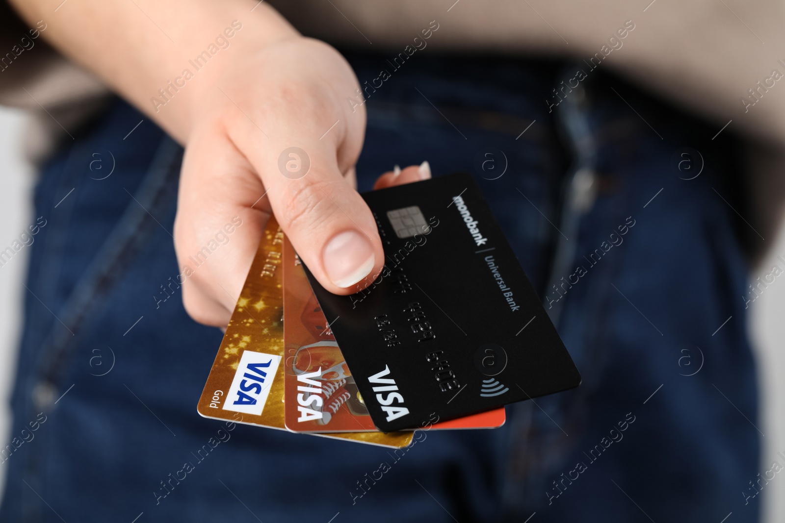 Photo of MYKOLAIV, UKRAINE - FEBRUARY 22, 2022: Woman holding Visa credit cards, closeup