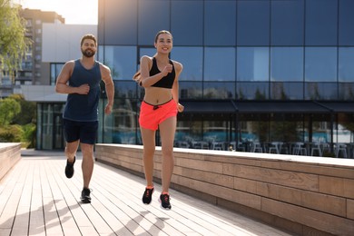 Photo of Healthy lifestyle. Happy couple running outdoors, space for text