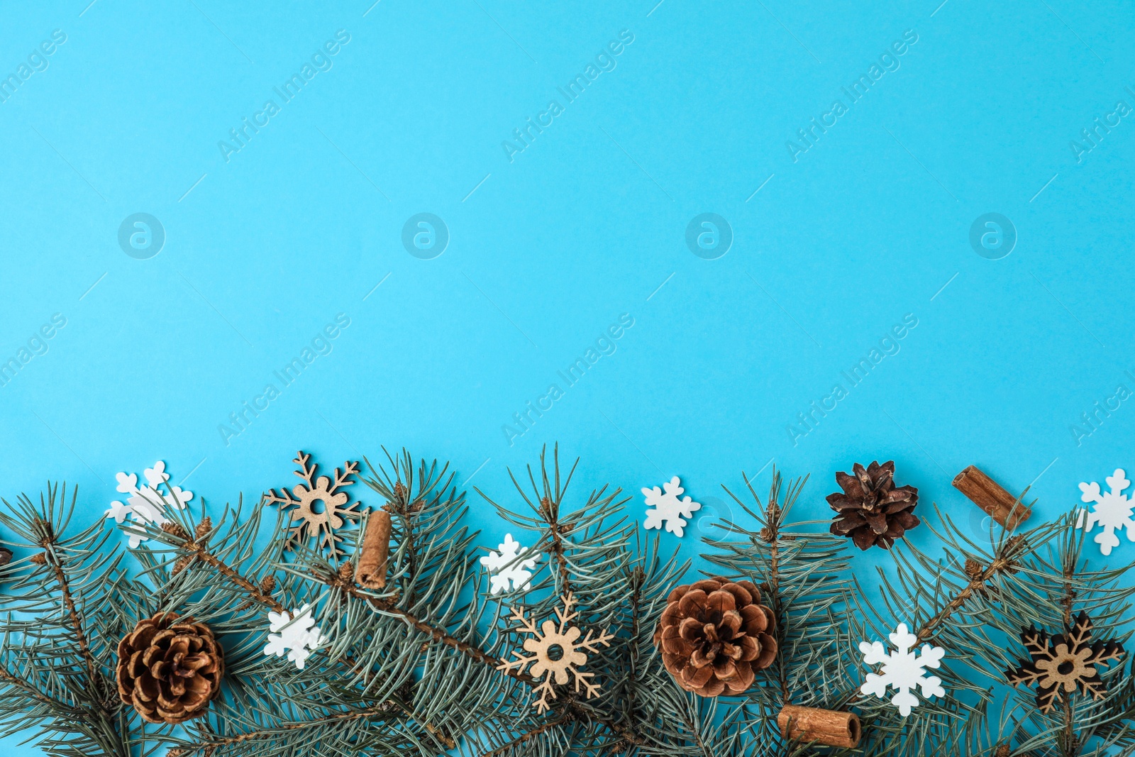 Photo of Winter composition with fir tree on light blue background, flat lay. Space for text